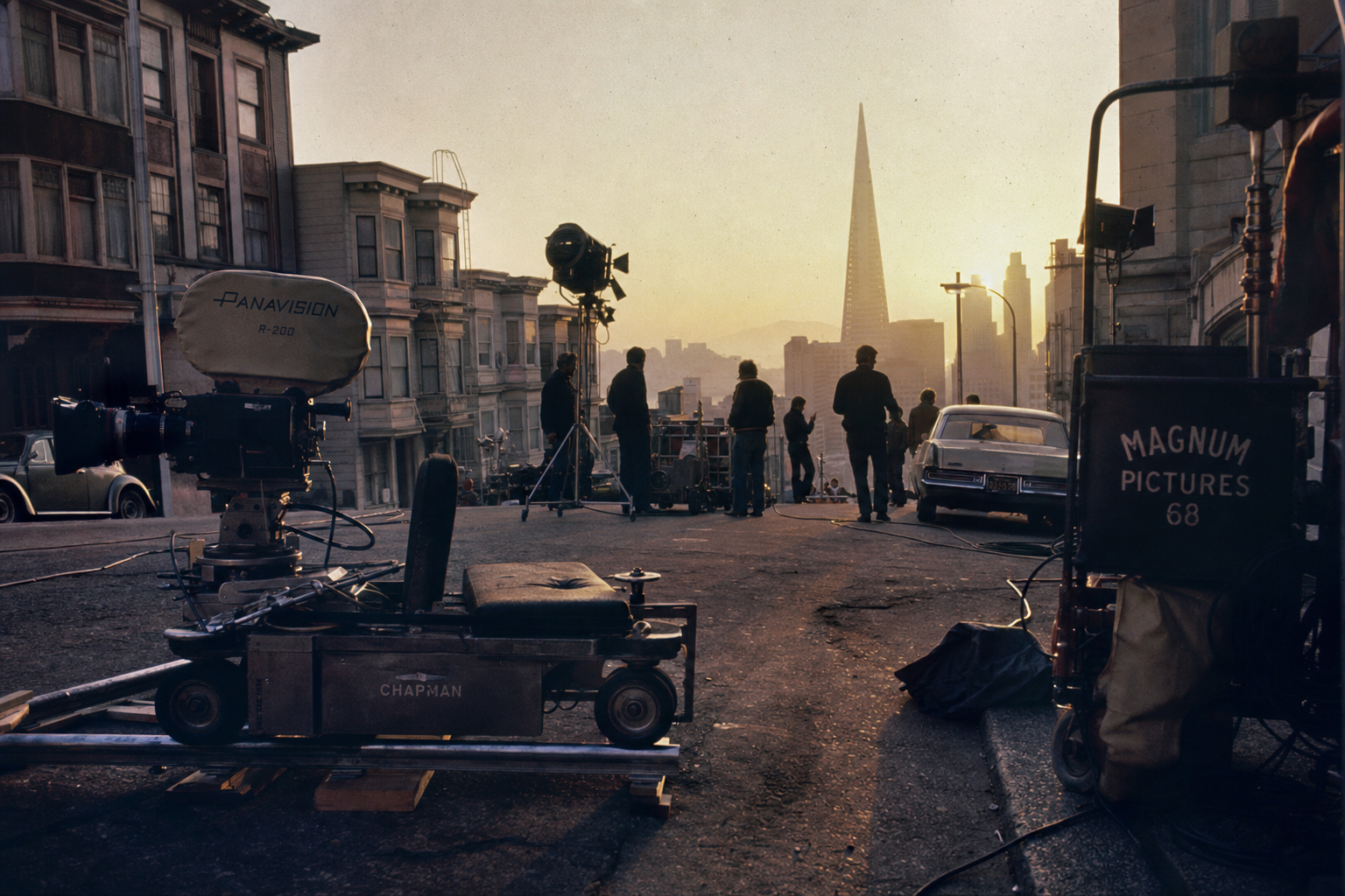 A 1968 film production crew on a San Francisco street at dawn, camera dolly and equipment visible with the Transamerica Pyramid in the background